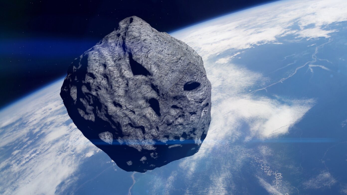 An asteroid with Earth in the background.