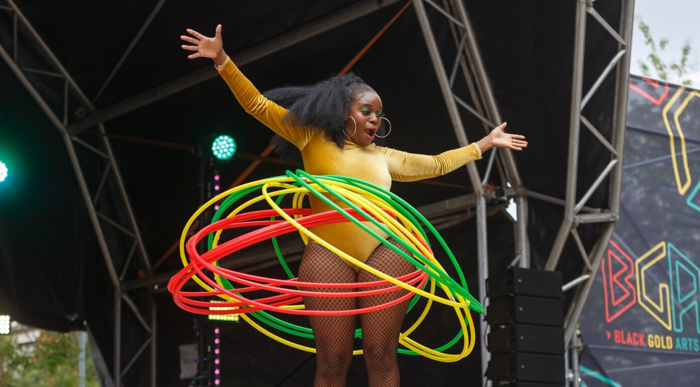 Hula hoop dancer performing on stage.