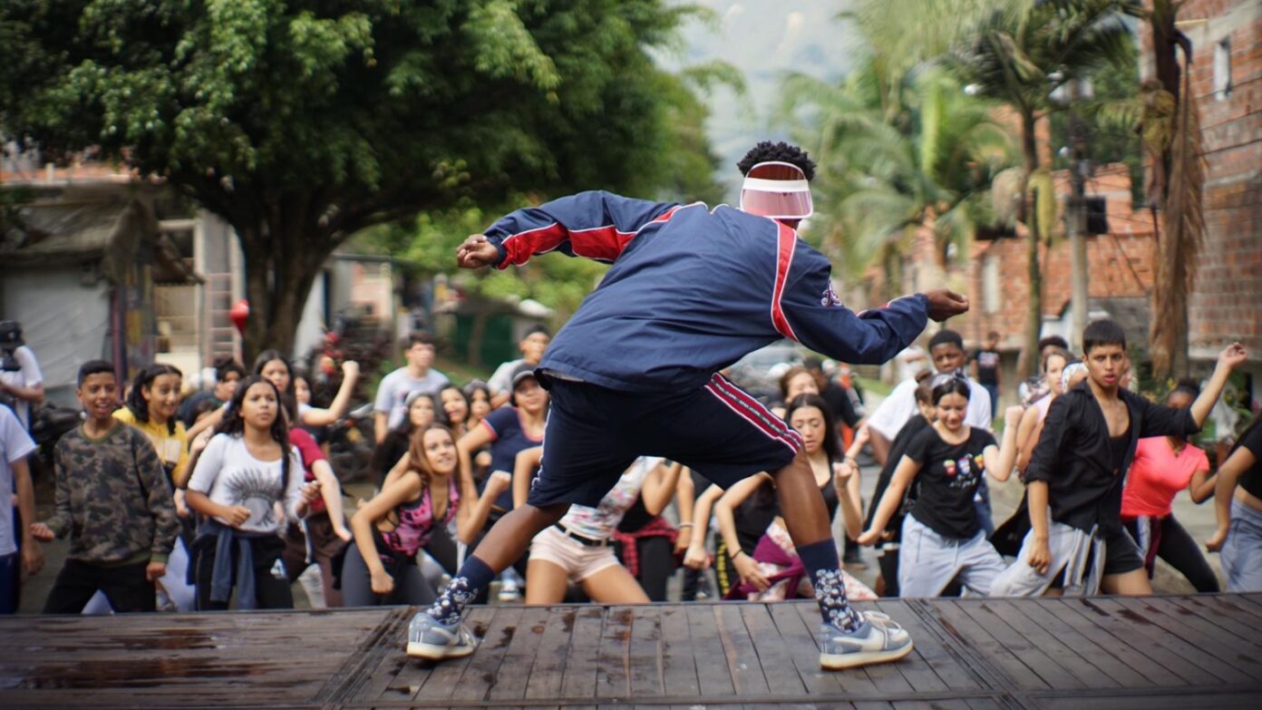 Man dances in front of a crowd.