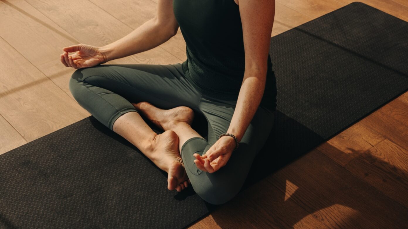 A woman doing yoga on a mat.